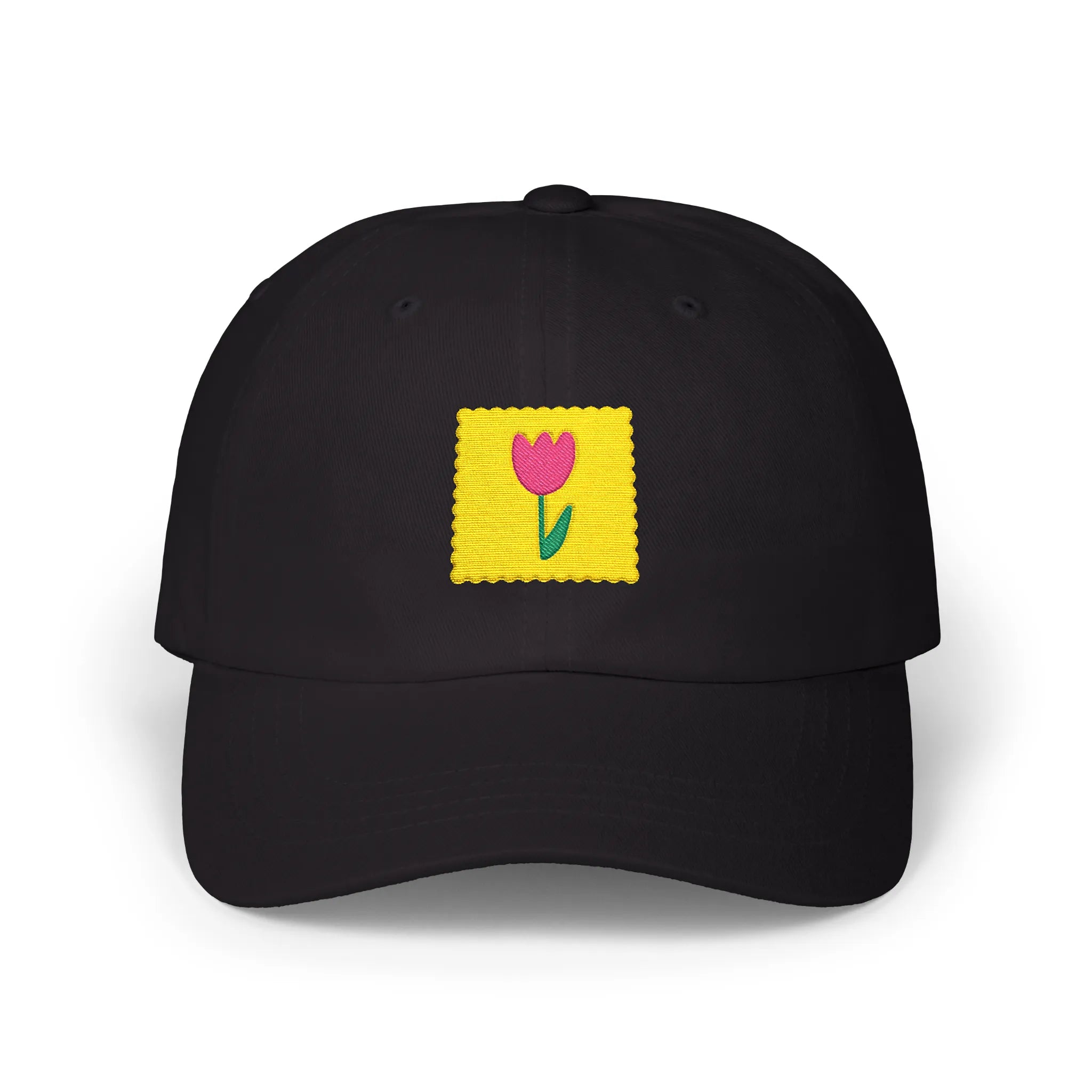 Black flower stamp baseball cap, front view with yellow stamp patch and pink flower embroidery