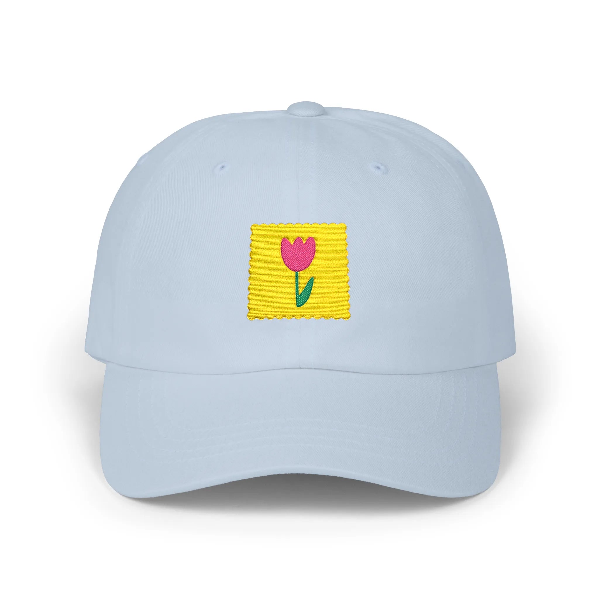 Light Blue flower stamp baseball cap, front view with yellow stamp patch and pink flower embroidery
