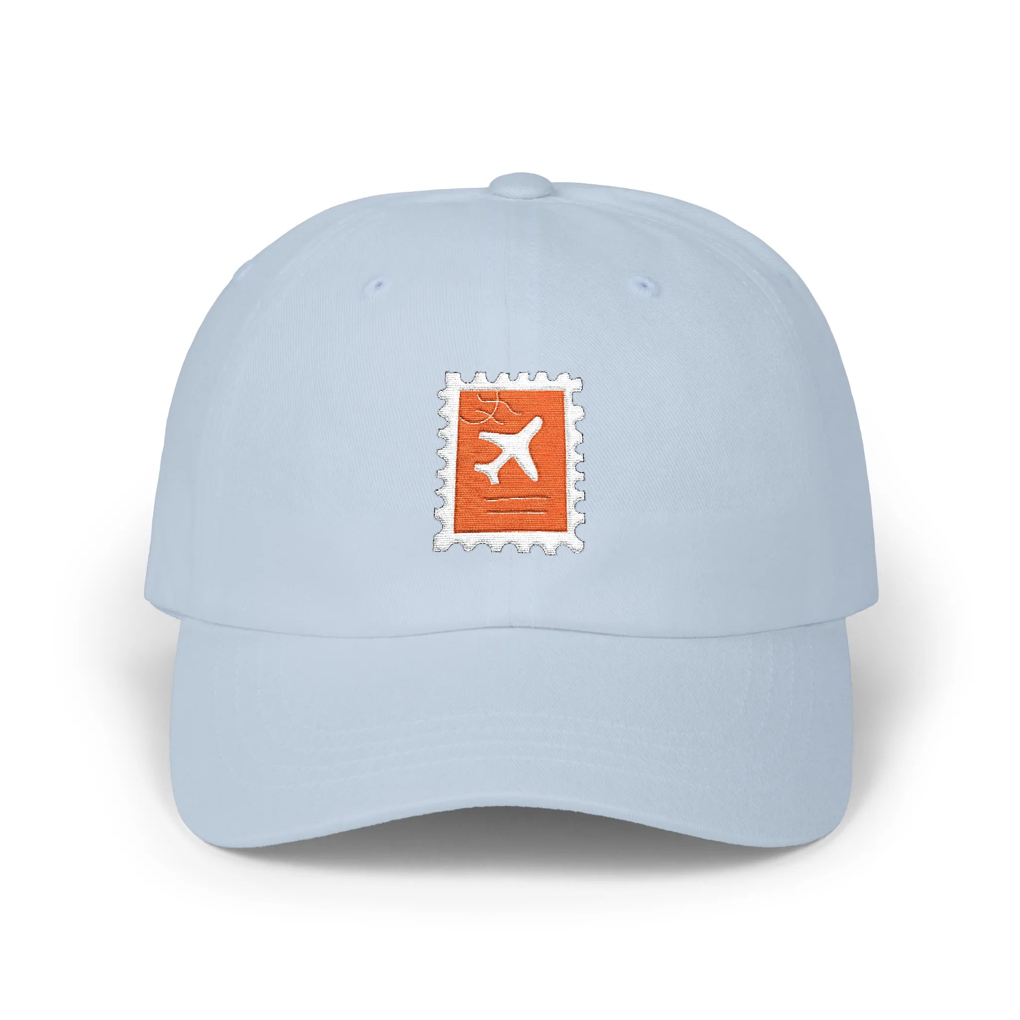Light Blue plane ticket baseball cap, front view with orange stamp and airplane embroidery