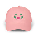 Pink heart and leaves baseball cap, front view with pink heart framed by green leaf branches