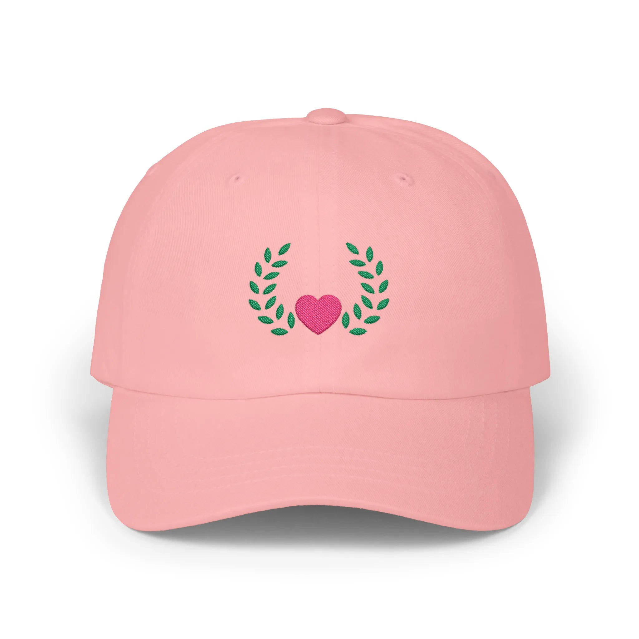 Pink heart and leaves baseball cap, front view with pink heart framed by green leaf branches