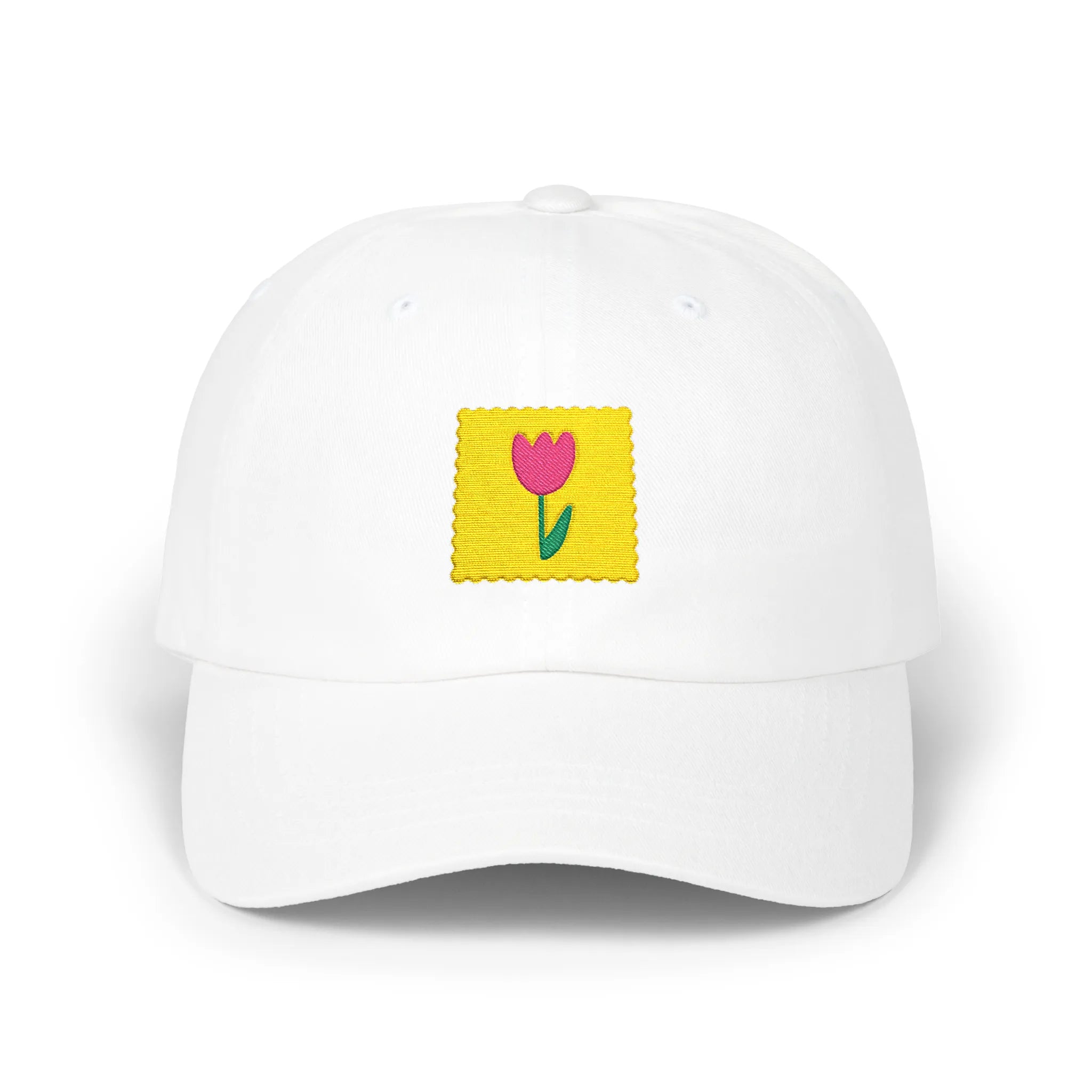 White flower stamp baseball cap, front view with yellow stamp patch and pink flower embroidery